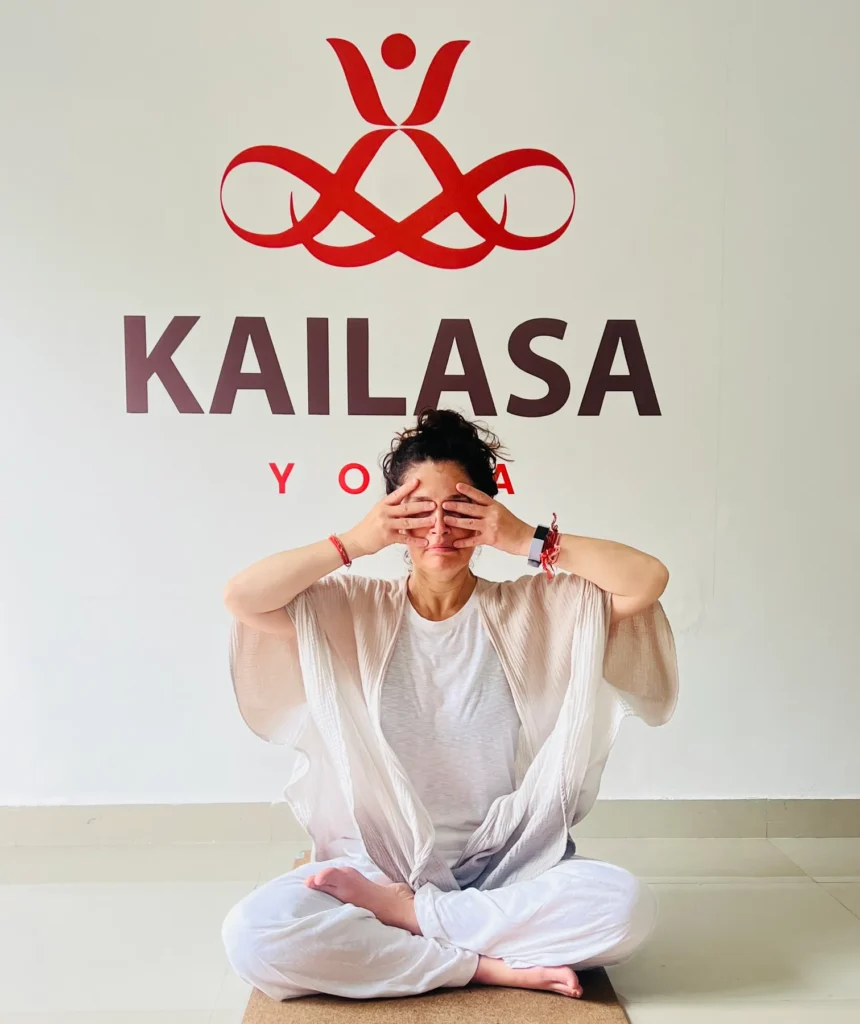 Person practicing Bhramari Pranayama at the Kailasa Yoga studio in Jahnavi Wellness