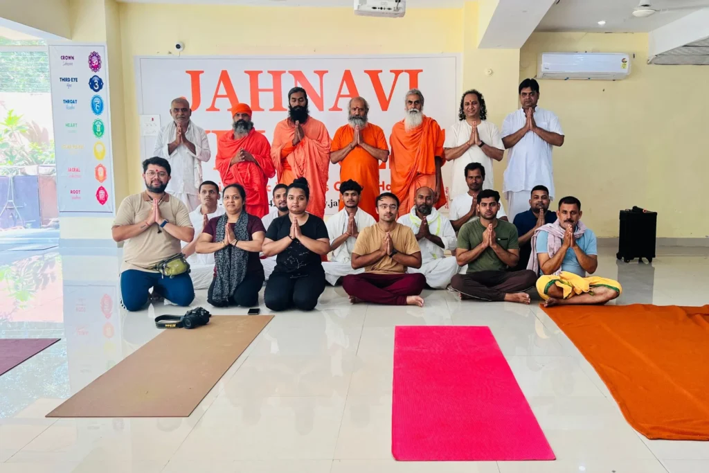 Group photo of participants and spiritual teachers at a yoga and wellness center.