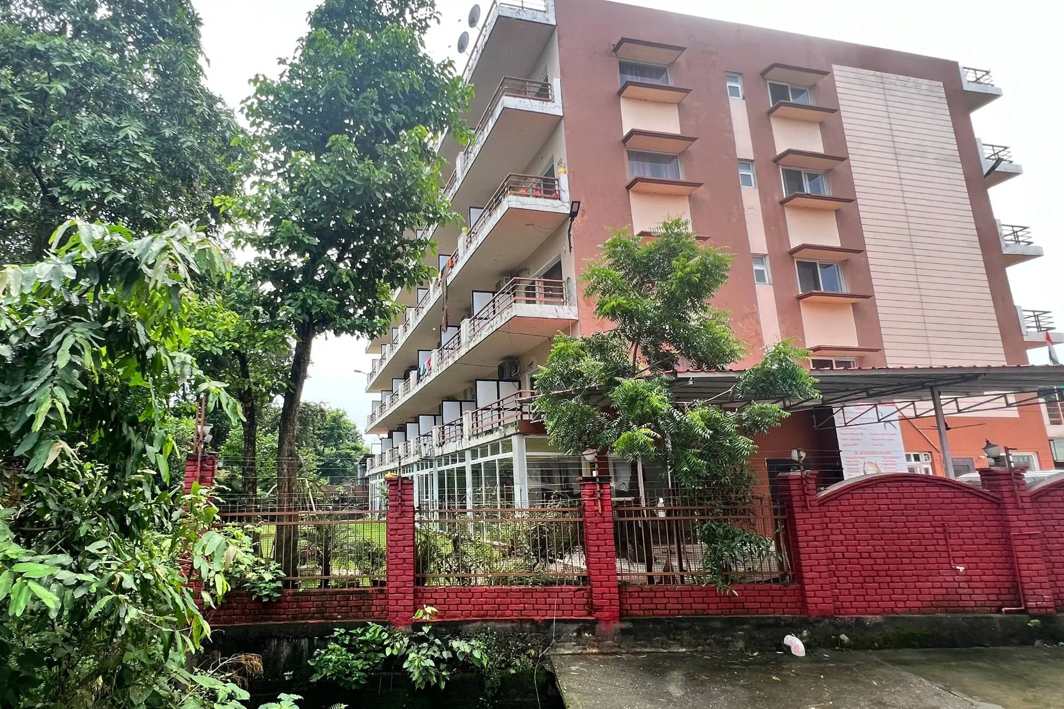 Exterior view of a multi-storey building surrounded by greenery.