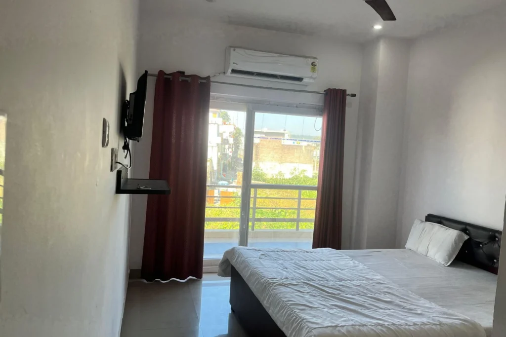 Sadhak Room at Jahnavi Wellness Centre — simple AC room with balcony in Haridwar