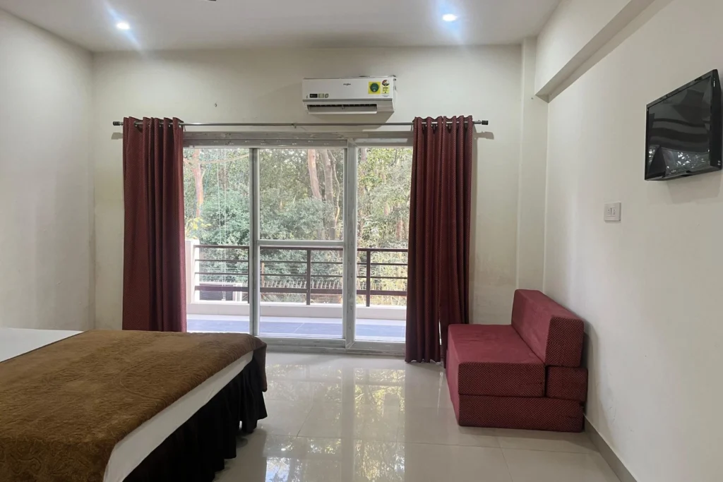 Standard Room at Jahnavi Wellness Centre with AC, balcony and forest view