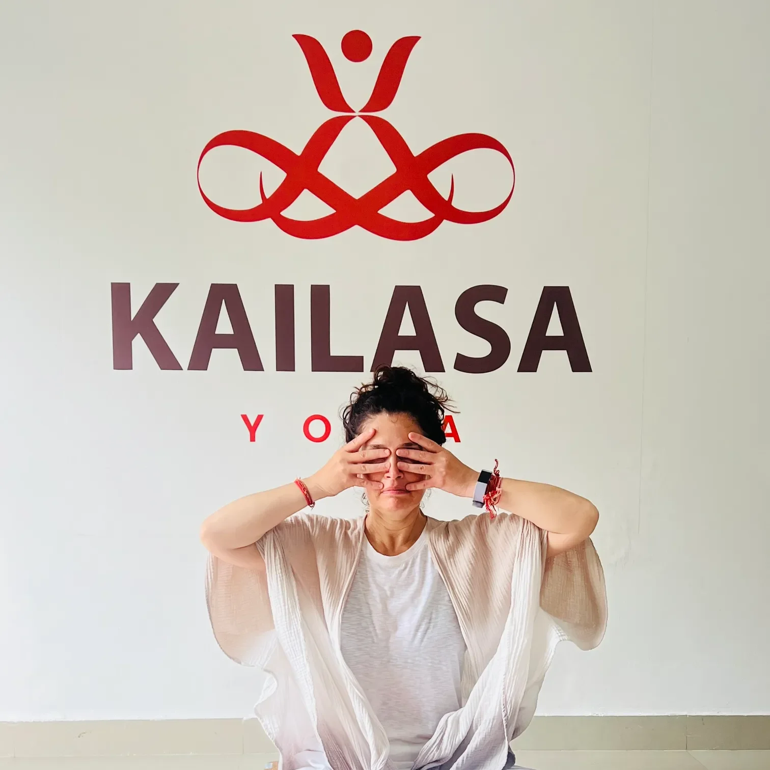 Person practicing Bhramari Pranayama at the Kailasa Yoga studio in Jahnavi Wellness